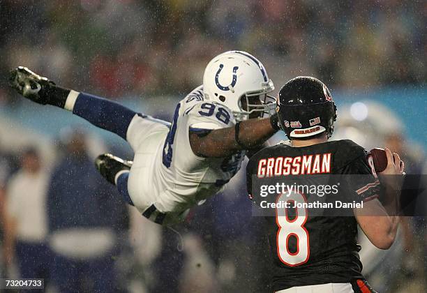 Quaterback Rex Grossman of the Chicago Bears drops back to pass as Robert Mathis of the Indianapolis Colts dives in during Super Bowl XLI on February...