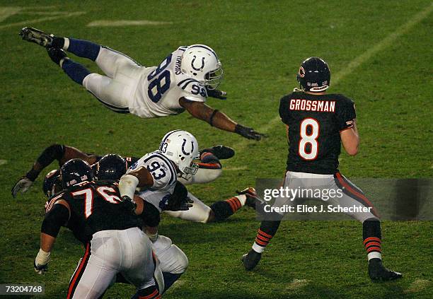 Quaterback Rex Grossman of the Chicago Bears drops back to pass as Robert Mathis of the Indianapolis Colts dives in during Super Bowl XLI on February...