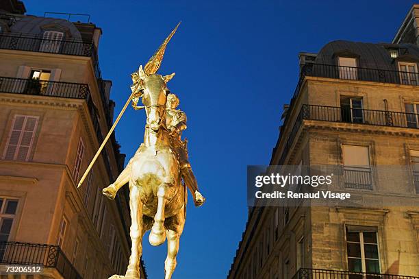 france, paris, statue of joan of arc at night, low angle view - place des pyramides stock pictures, royalty-free photos & images