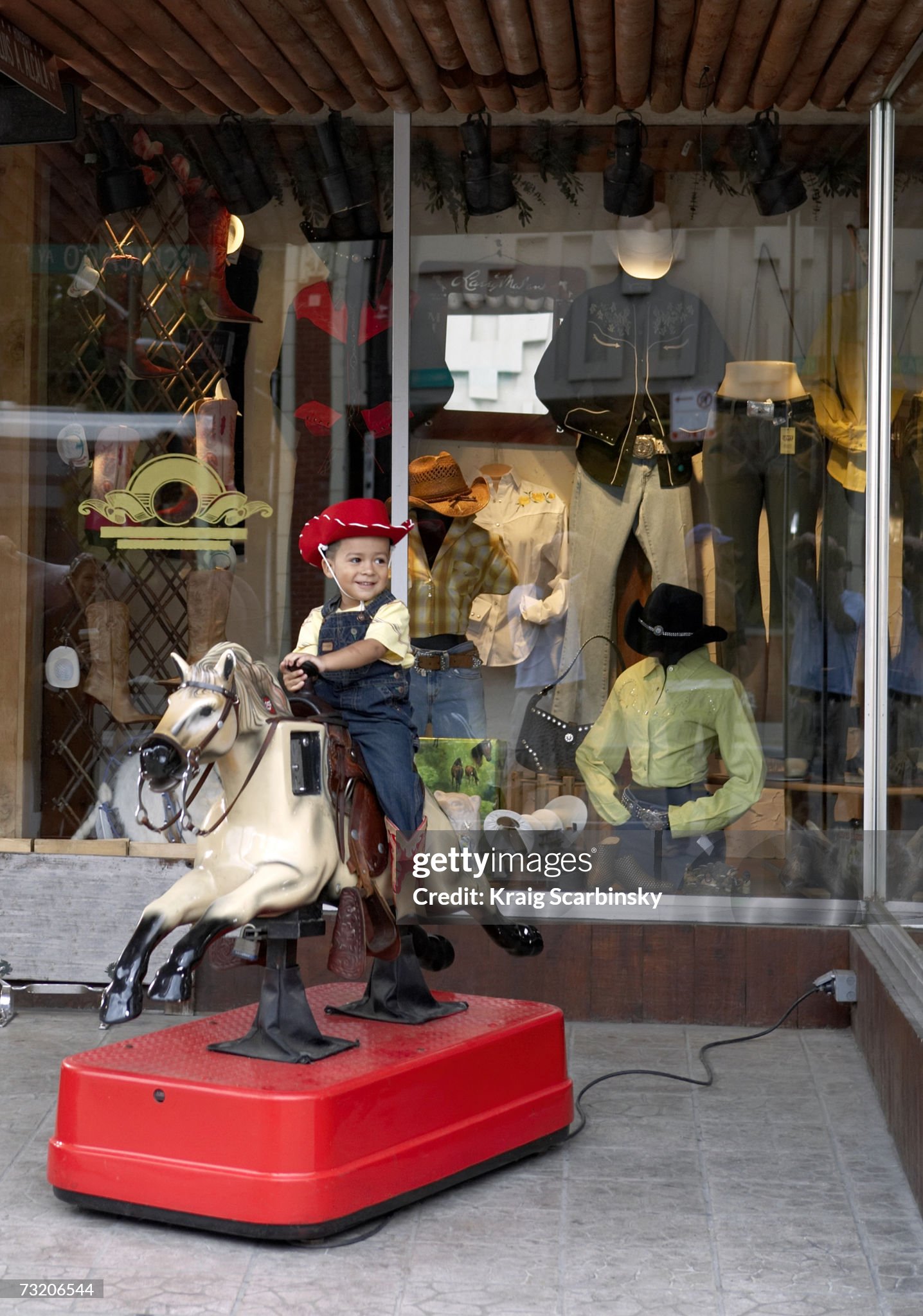 boy-riding-on-coin-operated-horse-outside-store.jpg