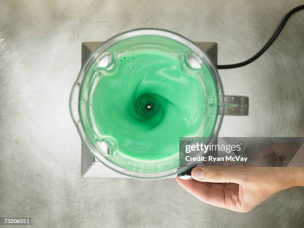 woman switching blender, overhead view, close up of hand - mixer stock-fotos und bilder