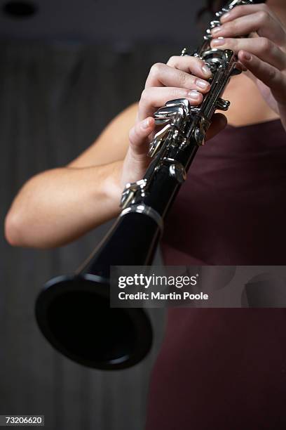 woman playing clarinet, close-up of hands - 木管楽器 ストックフォトと画像