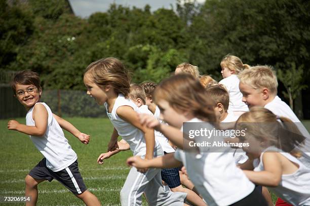 children (5-7) running on field - boys long hair styles stock pictures, royalty-free photos & images