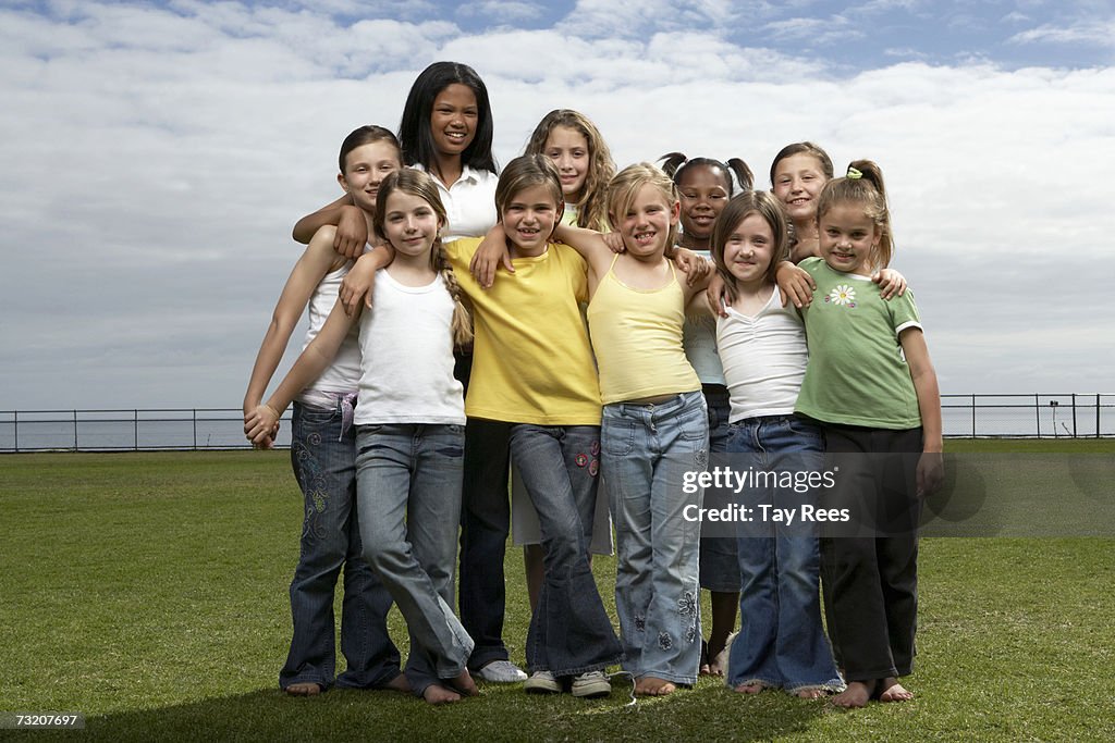 Group of girls (6-14) standing in field