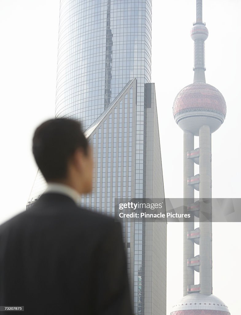 Businessman near modern office buildings