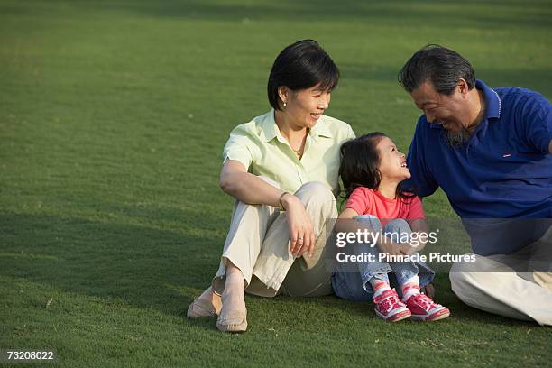 grandparents with granddaughter (4-5) in park - 45 49 år bildbanksfoton och bilder