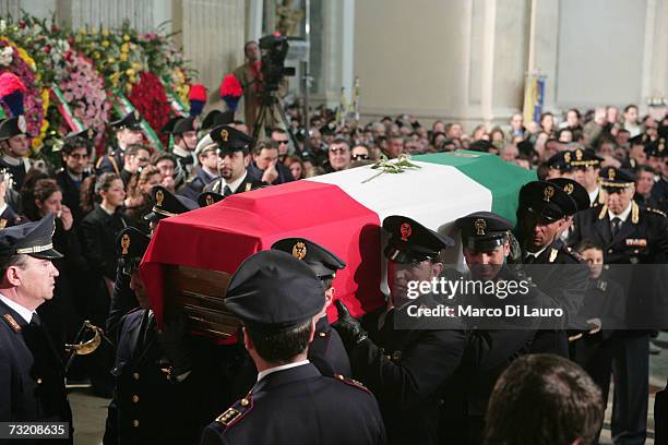 Police officers carry the coffin of officer Filippo Raciti at his funeral on February 4, 2007 in Catania, Italy. Raciti died of his injuries received...