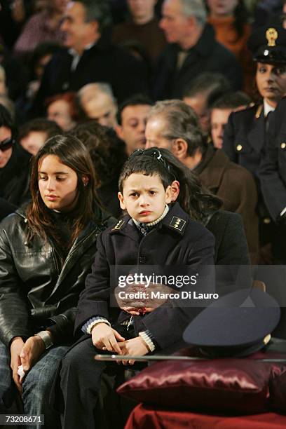 Marisa Raciti, wife of murdered Italian Police officer Filippo Raciti sits behind her 8-year-old son Alessio and 14-year-old daughter Fabiana at his...