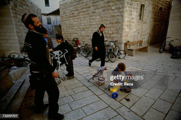 Men, women and children go about their daily life in a Jewish district on May, 2001 in Hebron, West Bank.