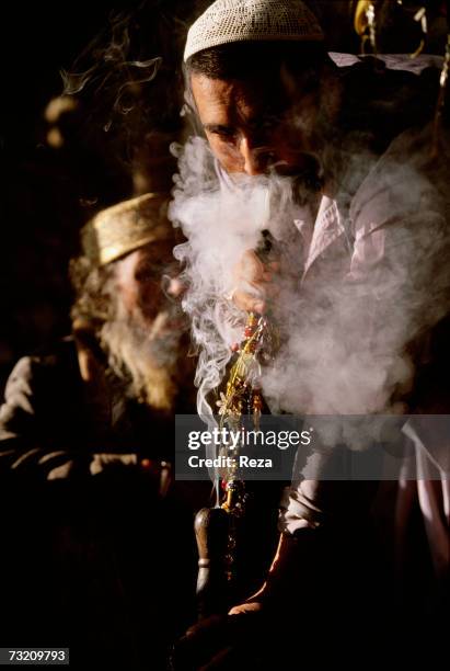 The followers of a hermit regularly get together to smoke hashish in a water pipe, on April in Pir Baba, within the Pashtun tribal zone of Mohmand,...