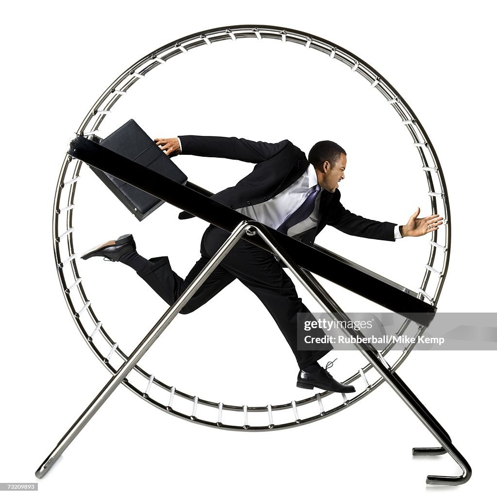 Businessman running in hamster wheel