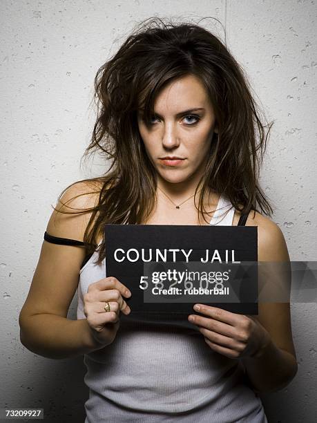 mug shot of disheveled woman - police mugshot stock-fotos und bilder