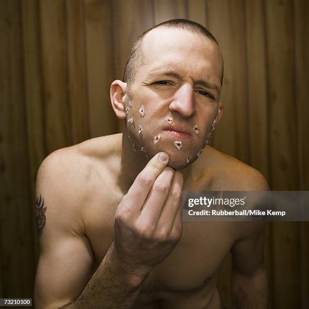 shirtless man with cuts on face from shaving - wood shaving stock pictures, royalty-free photos & images