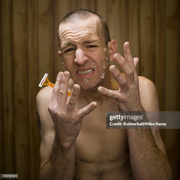 shirtless man with cuts on face from shaving - wood shaving stock pictures, royalty-free photos & images