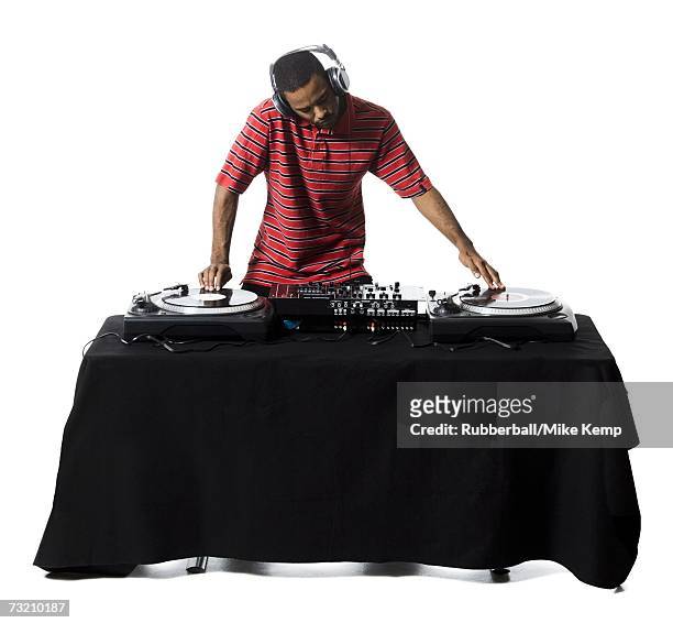 dj with headphones spinning records - dj ストックフォトと画像