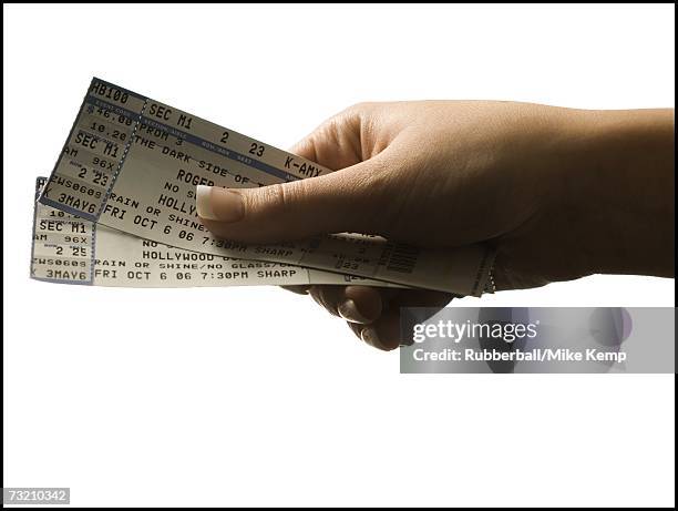 woman holding concert tickets - concert ticket stock pictures, royalty-free photos & images