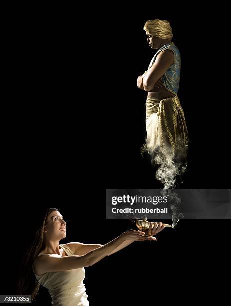 woman with magic lantern and genie - djinn stockfoto's en -beelden