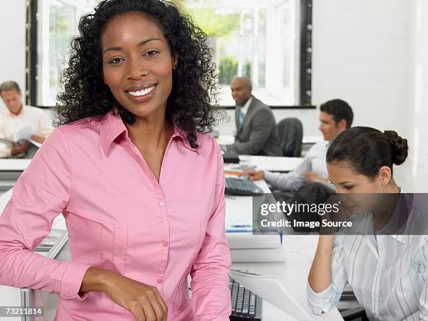 businesswoman in office - pink shirt stock pictures, royalty-free photos & images