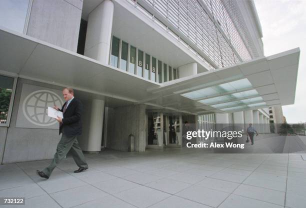 Man passes by the main entrance of the World Bank headquarters main complex September 18, 2000 in Washington, D.C.