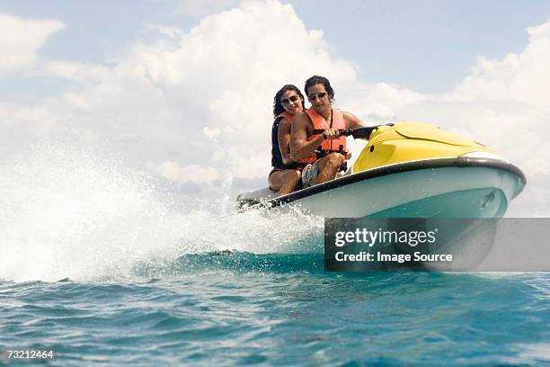 couple riding jet ski - jet ski stock pictures, royalty-free photos & images