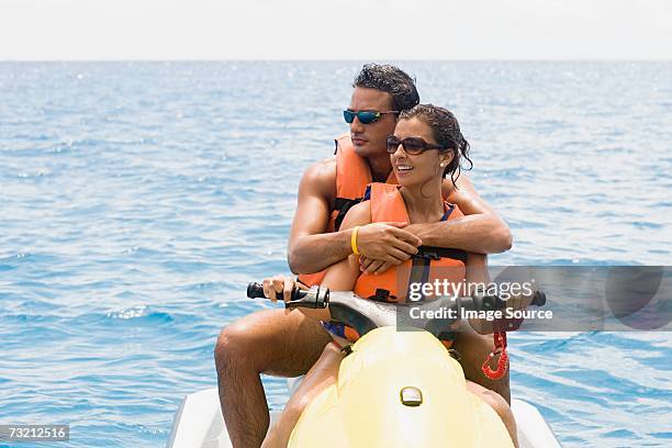 couple riding jet ski - jet ski stock pictures, royalty-free photos & images