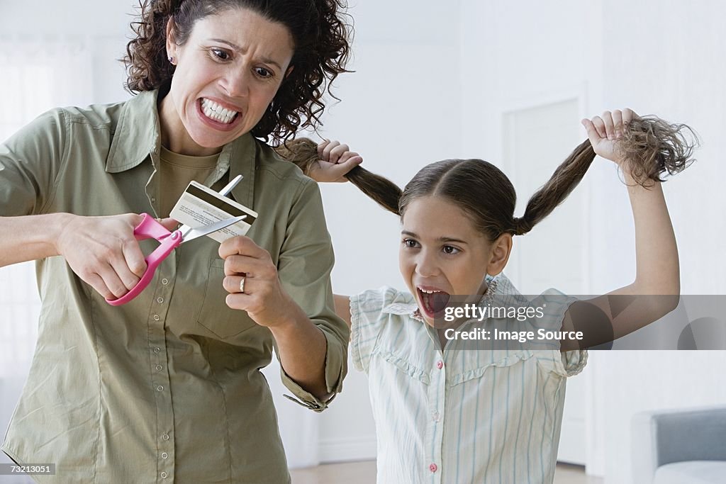 Mother cutting up a credit card