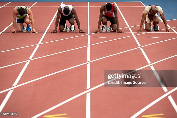 four sprinters on a race track - starting line stock pictures, royalty-free photos & images