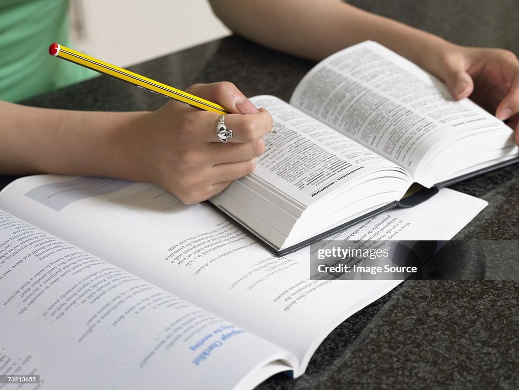 Student with dictionary and textbook