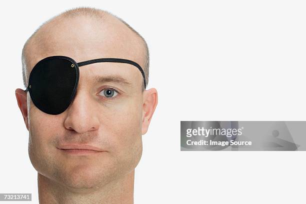 man wearing eye patch - eye patch stock pictures, royalty-free photos & images