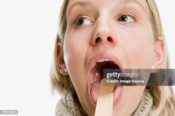 woman having medical examination - tongue depressor stock pictures, royalty-free photos & images