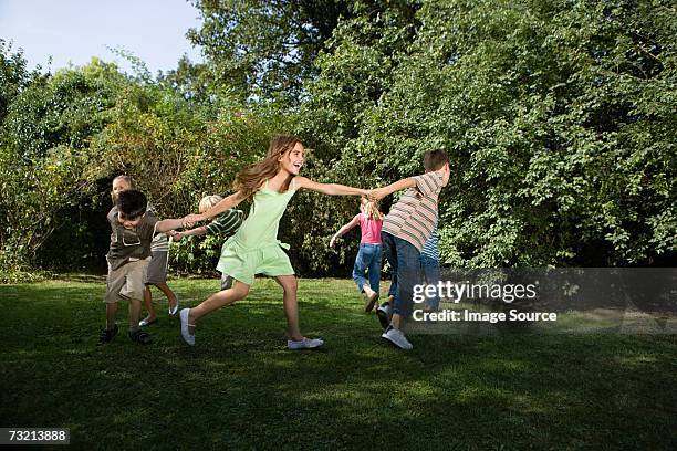 children playing a game - person chained to tree stock pictures, royalty-free photos & images