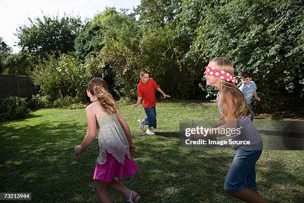 children playing blind mans bluff - blinddoek stockfoto's en -beelden