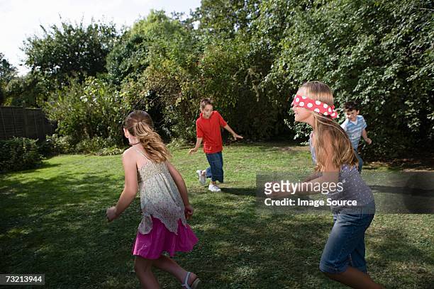 children playing blind mans bluff - blindfold stock pictures, royalty-free photos & images