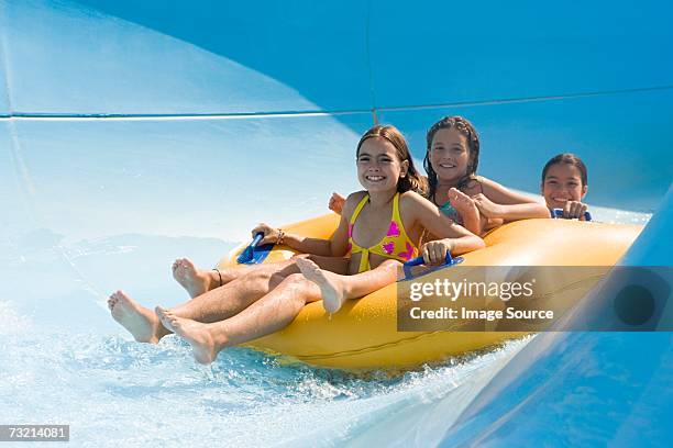 girls on a water slide - water slide stock pictures, royalty-free photos & images