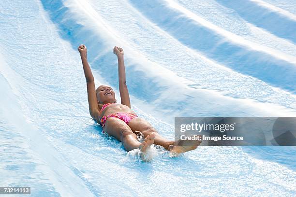 girl on a water slide - water slide stock pictures, royalty-free photos & images