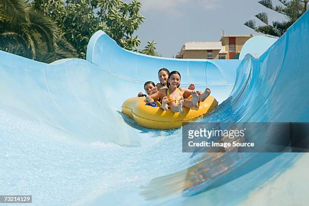 friends on a water slide - waterslide bildbanksfoton och bilder
