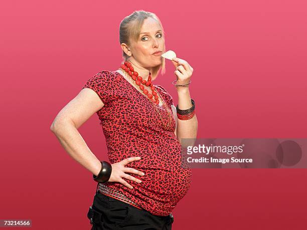 pregnant woman eating a crisp - family eating potato chips stock pictures, royalty-free photos & images