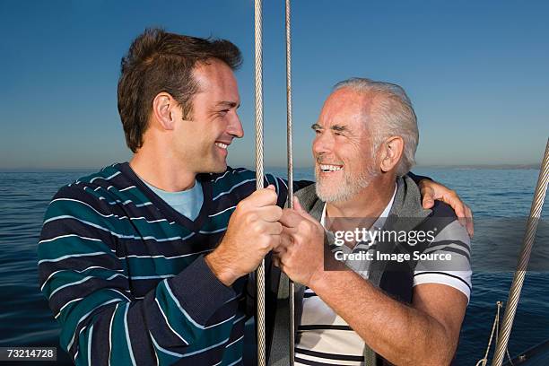 father and son sailing - father son sailing stock pictures, royalty-free photos & images