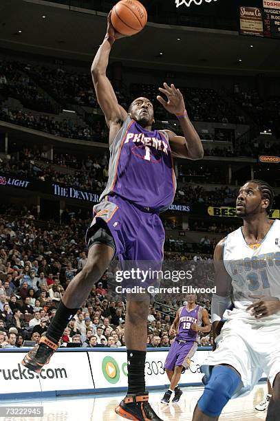 Amare Stoudemire of the Phoenix Suns goes to the basket against Nene of the Denver Nuggets on February 5, 2007 at the Pepsi Center in Denver,...