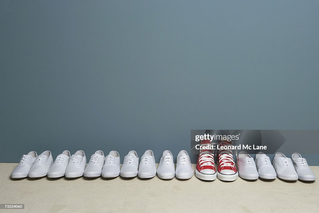 Pair of shoes in row against wall