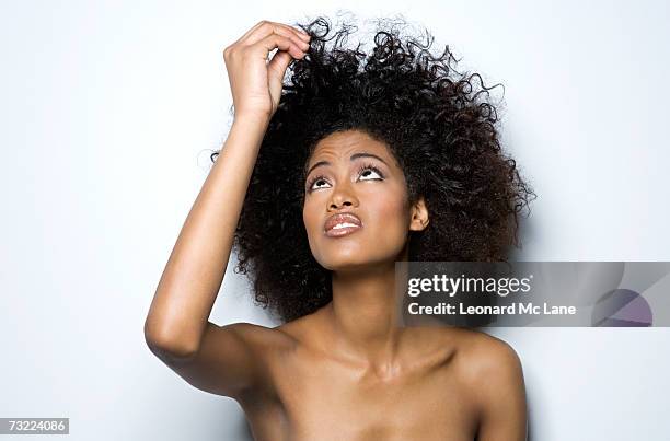 young woman holding up her hair, close-up - pulling hair stock pictures, royalty-free photos & images