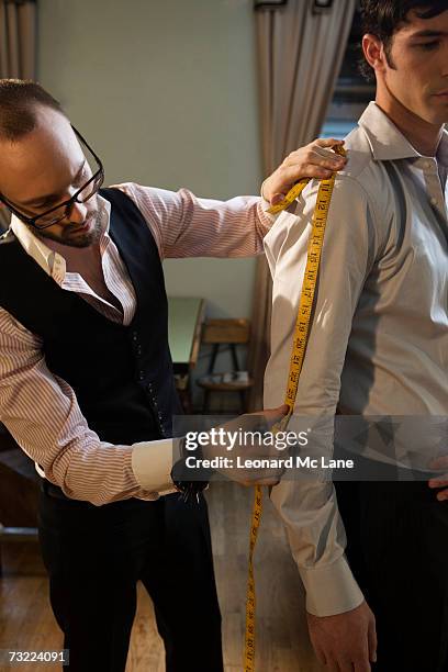 tailor measuring man in shirt, close-up - measuring stock pictures, royalty-free photos & images