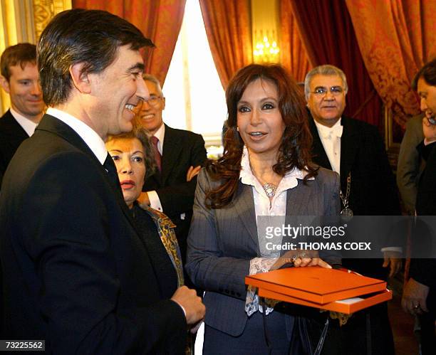 French Foreign Minister Philippe Douste-Blazy offers a gift to Argentinian President Nestor Kirchner's wife, Senator Cristina Fernandez De Kirchner,...
