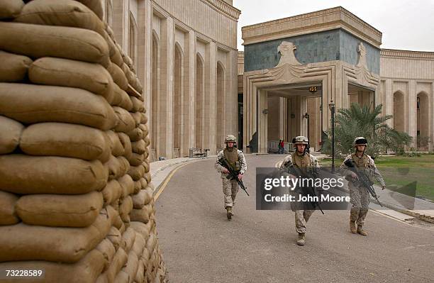 Marines walk past the front of the American Embassy February 6, 2007 in Baghdad, Iraq . The platoon of Marines from the Anti-Terrorism Battalion is...