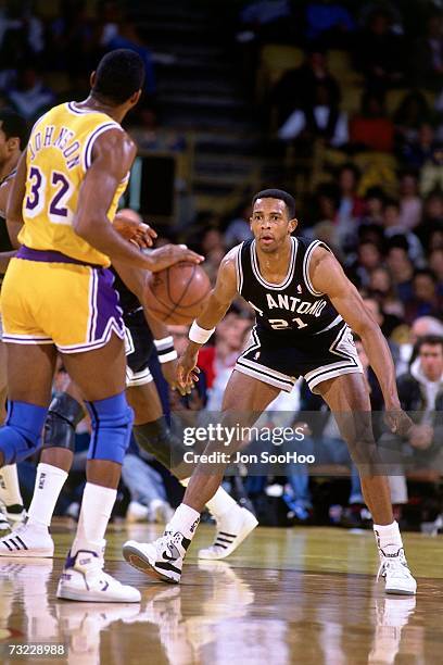 Alvin Robertson of the San Antonio Spurs defends against Magic Johnson of the Los Angeles Lakers during a game played in 1989 at the Great Western...