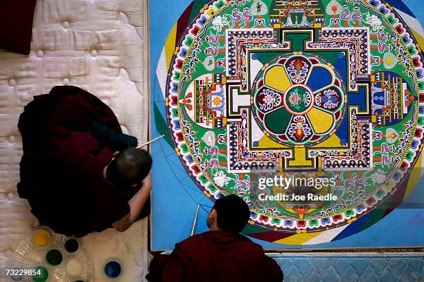 Tibetan monks work on creating an intricate sand drawing, known as a mandala, at the Broward County Main Library February 6, 2007 in Fort Lauderdale,...