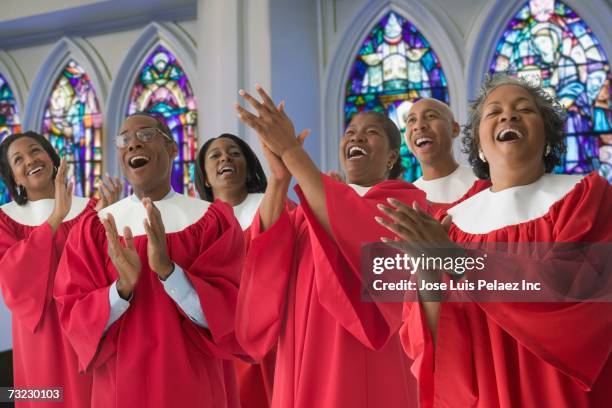 african men and women in church choir singing - african american church stock-fotos und bilder