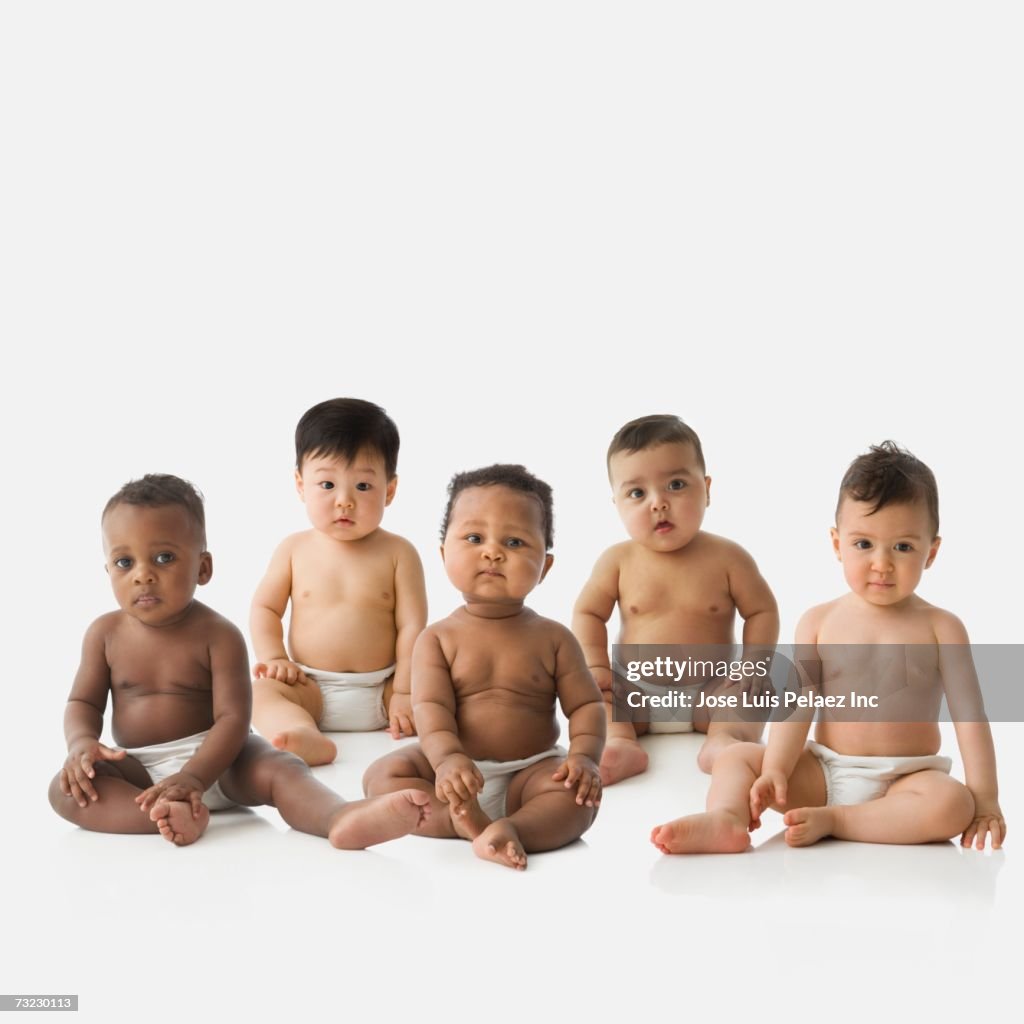 Studio shot of babies in diapers sitting