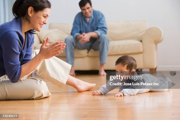 mother clapping with baby on floor - parents applauding stock pictures, royalty-free photos & images