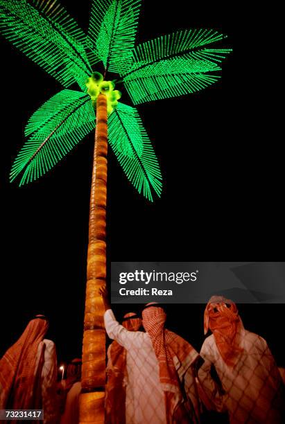 Electric palm tree on the beach at night during the Eid-ul-Fitr festivities on January, 2003 in Jeddah, Saudi Arabia.